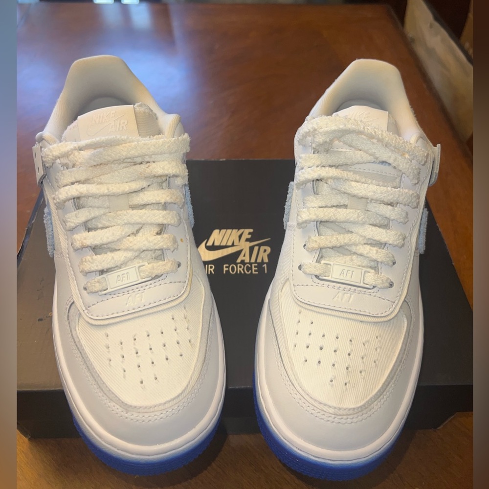 White and two blue toned Nike AF1s